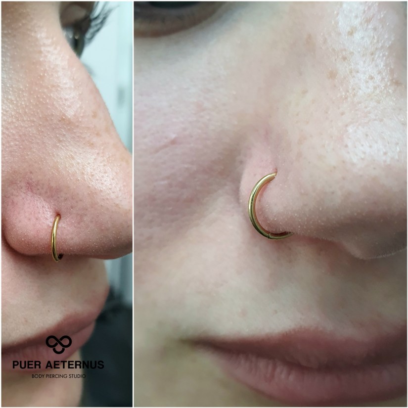 Nostril piercing menjava osnovnega nakita po zaključenem celjenju z zlato rinko, vstavljen v Puer Aeternus studiu v Sežani